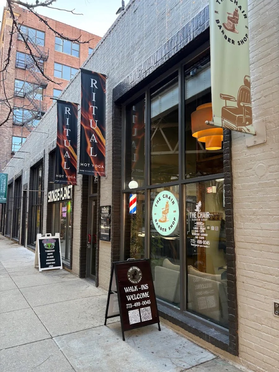 The Chair Barbershop storefront at 750 N Franklin St in River North, Chicago, with barber pole, window logo, and Walk-Ins Welcome sign